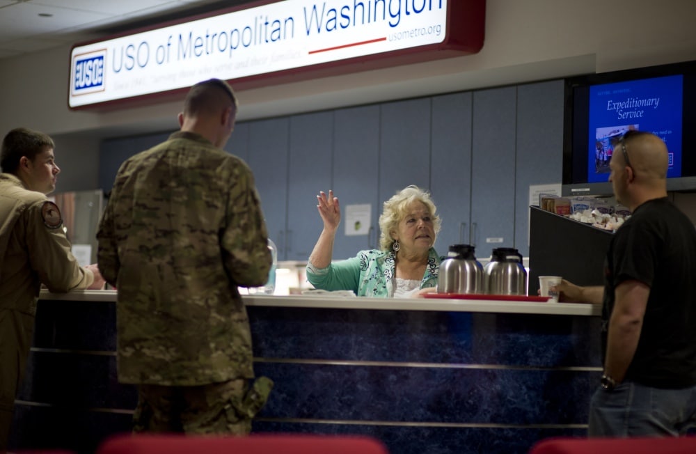 USO volunteer talking to service members