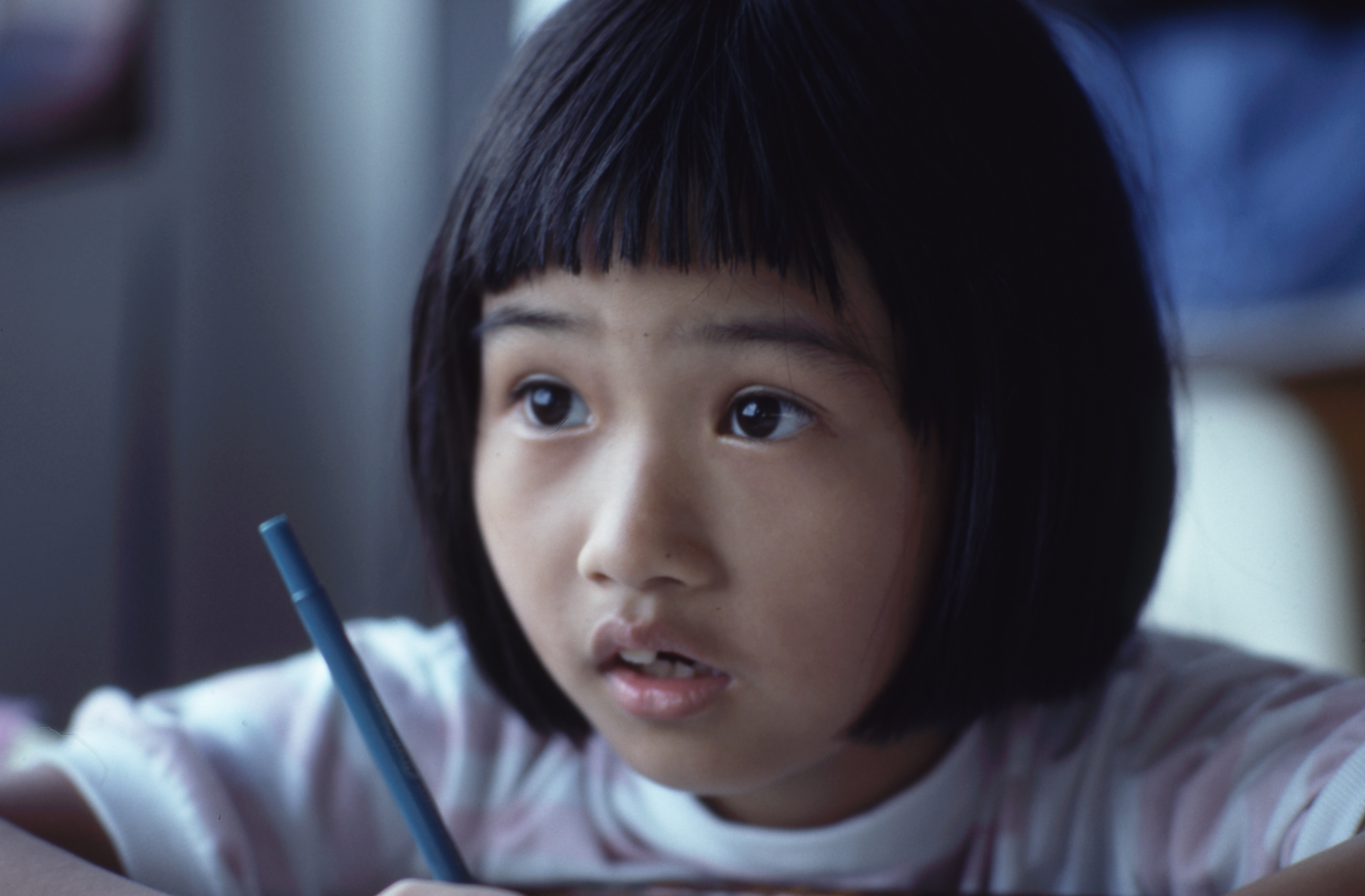 little girl with a pen