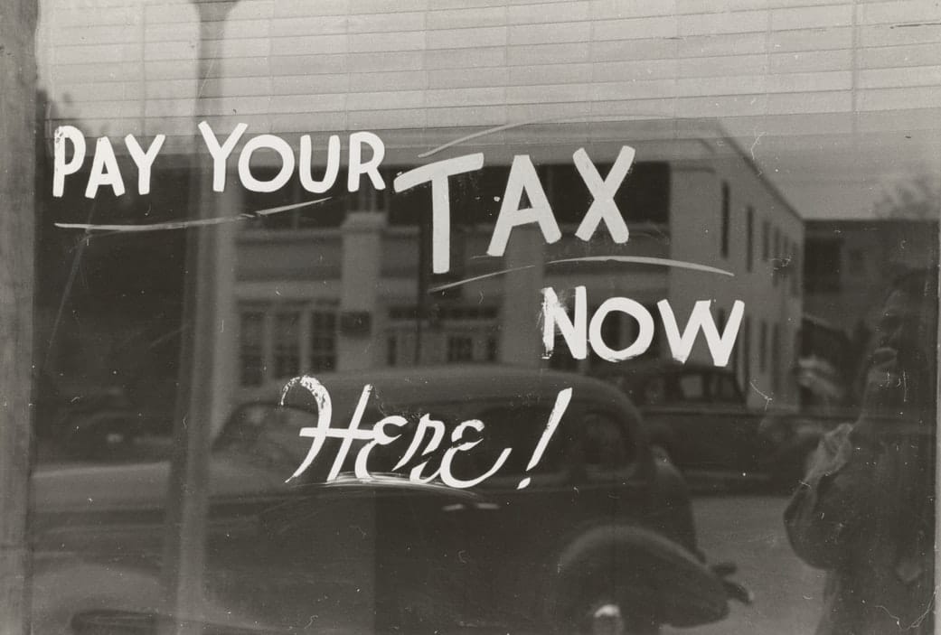 tax tip sign on window to pay tax here