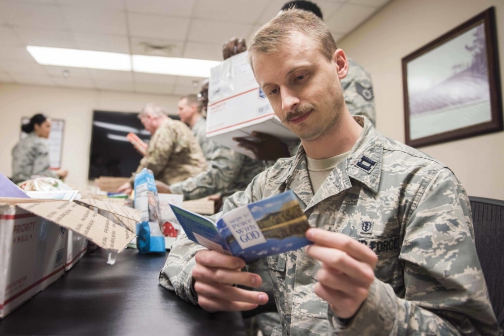 air force capt. reads a booklet from a care package