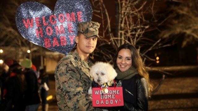 Corporal Jose Becerra poses for a photo with his wife during a homecoming event aboard Camp Lejeune, N.C., Jan. 14, 2015. Becerra returned from a six-month deployment in support of Special Purpose Marine Air-Ground Task Force Crisis Response-Africa. (U.S. Marine Corps photo by Lance Cpl. Alex Mitchell)