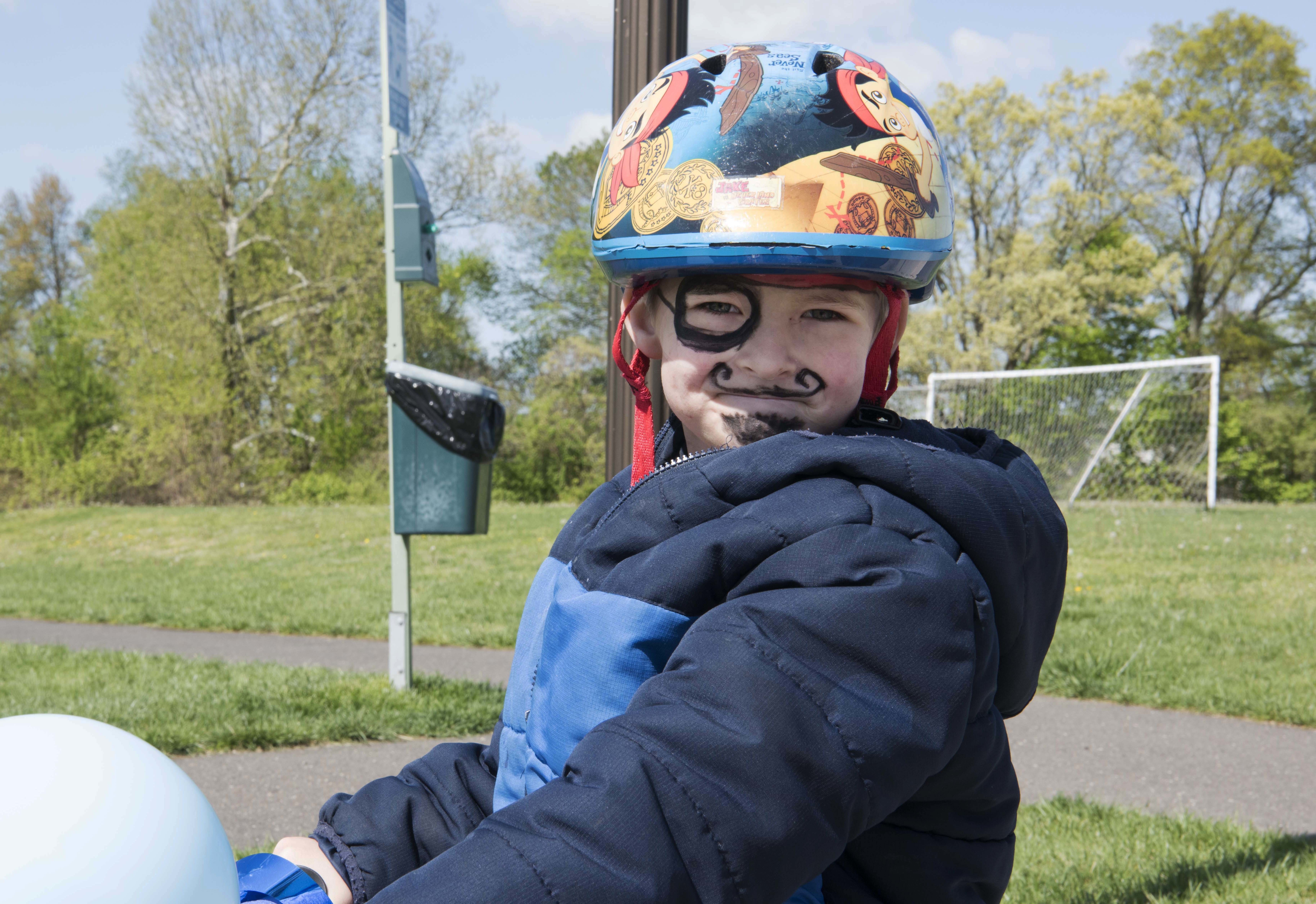 A military child imitates a pirate on his decorated bike at Family Advocacy’s Kid’s on Wheels Parade on Joint Base McGuire-Dix-Lakehurst, New Jersey, April 27, 2019. Child Abuse Prevention Month seeks to create a community of families that will educate and support each other against child abuse and neglect. For more information or help, call Family Advocacy at (609) 754-9680 or the 24/7 Hotline at (609) 283-5015. (U.S. Air Force photo by Airman 1st Class Briana Cespedes)