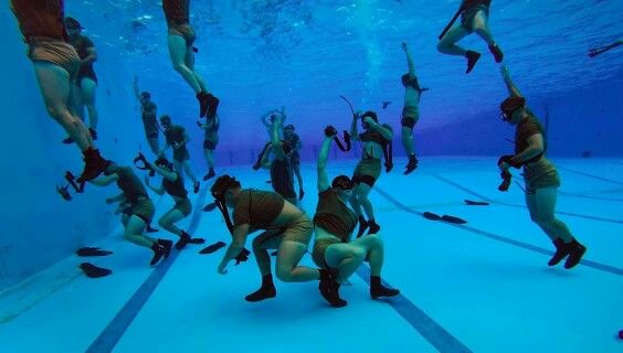 Students as the Combat Diver Qualification Course (CDQC) during an underwater exercise. A female cadet is set to become the first-ever woman combat diver (U.S. Army).