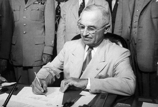 President Harry Truman signing the National Security Act into law on July 26, 1947