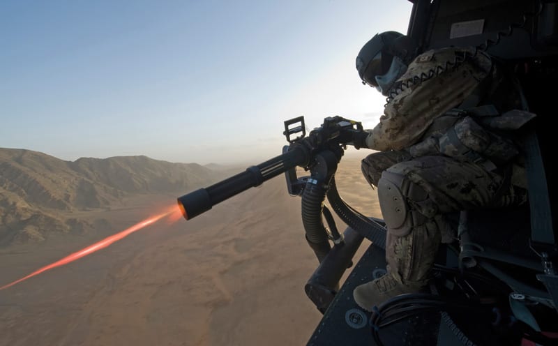 a minigun mounted on a helicopter