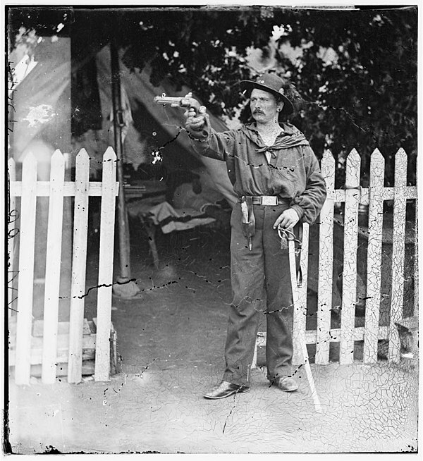 An American Civil War cavalryman holding a Savage 1861 revolver
