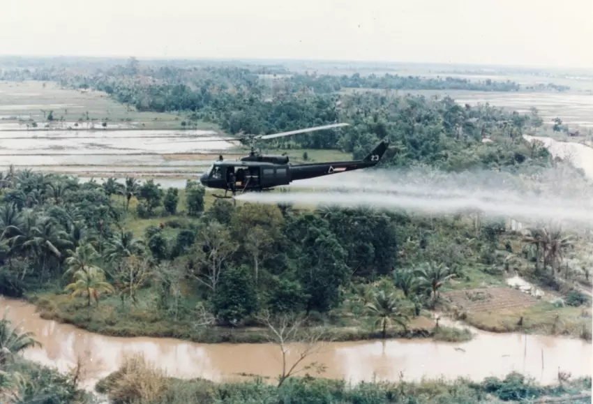 military helicopter sprays Agent Orange in Vietnam