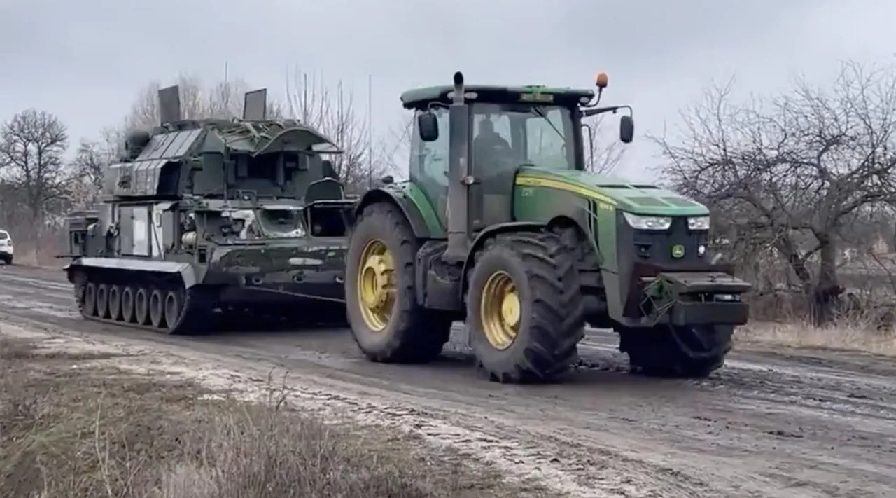Russian tank towed by Ukrainian tractor