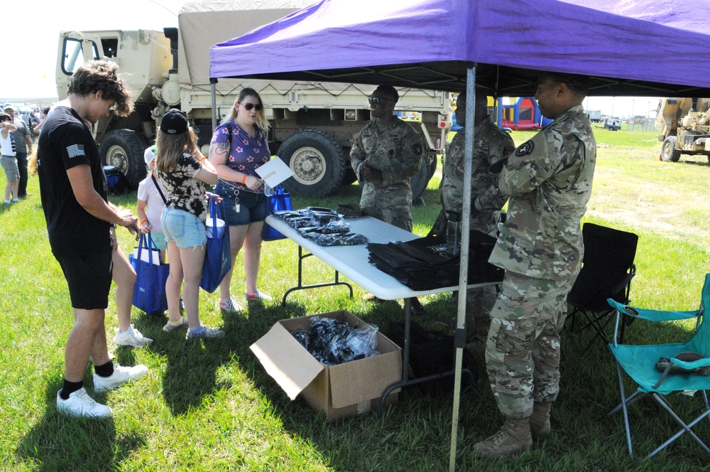 Army recruiters talk to people at air show