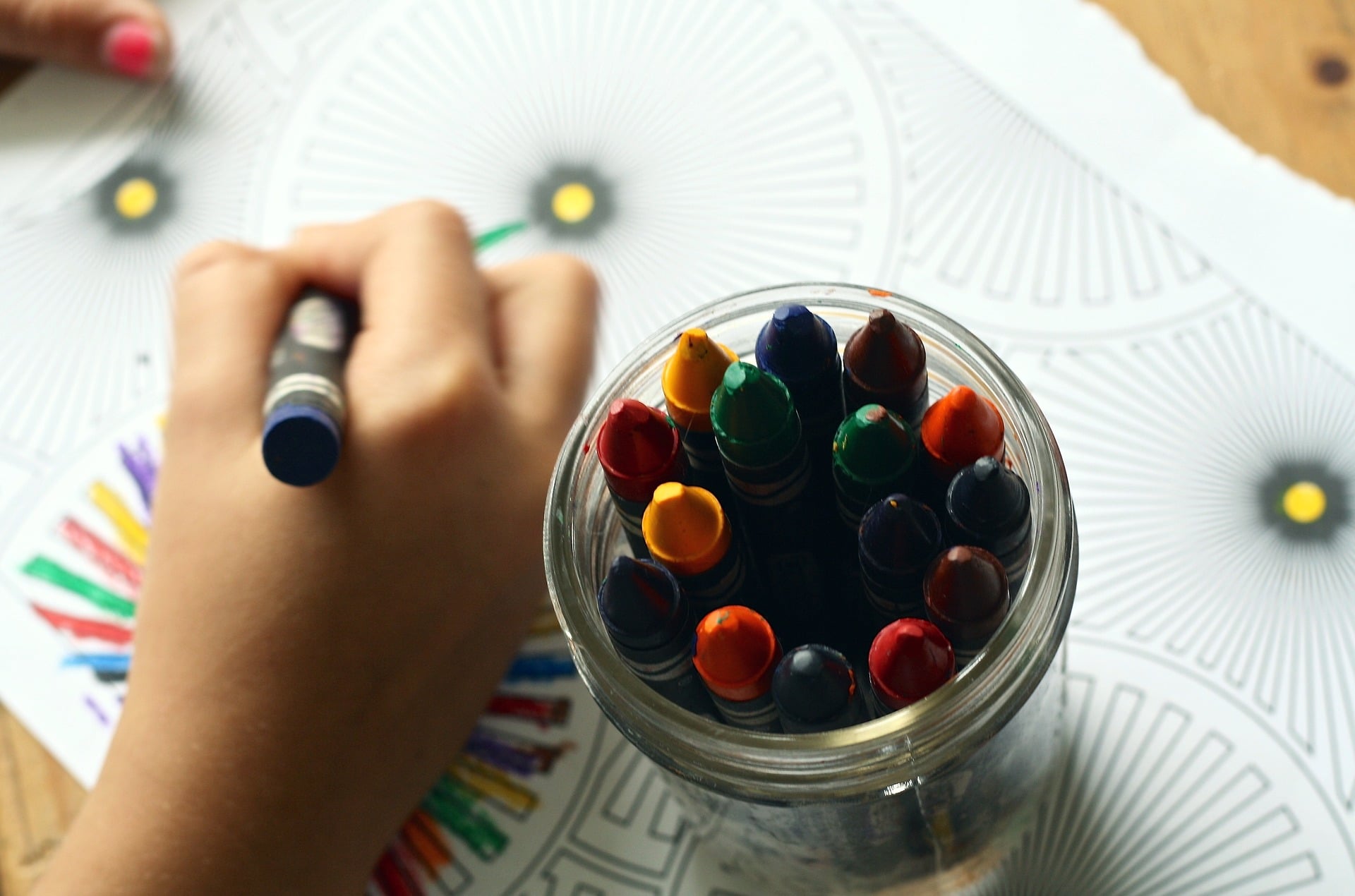child coloring with crayon