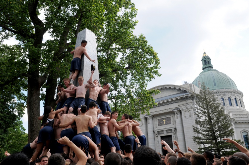Naval Academy freshmen climb Herndon Monument on campus