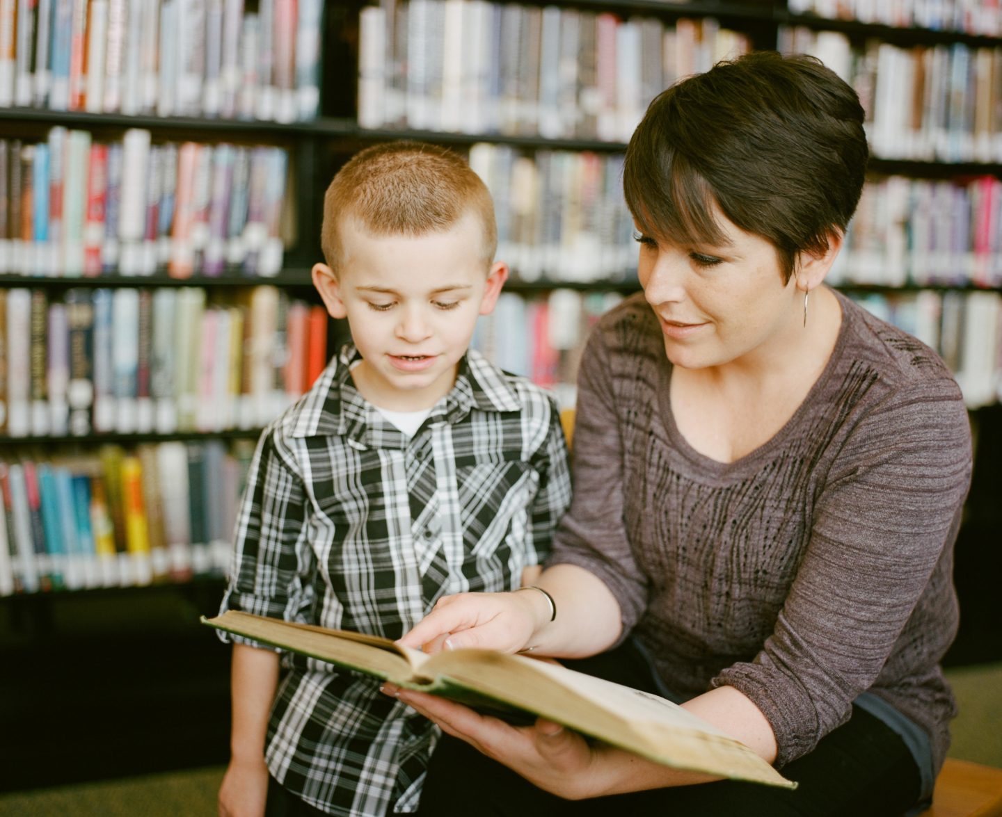 teach at home moment: mom showing son book