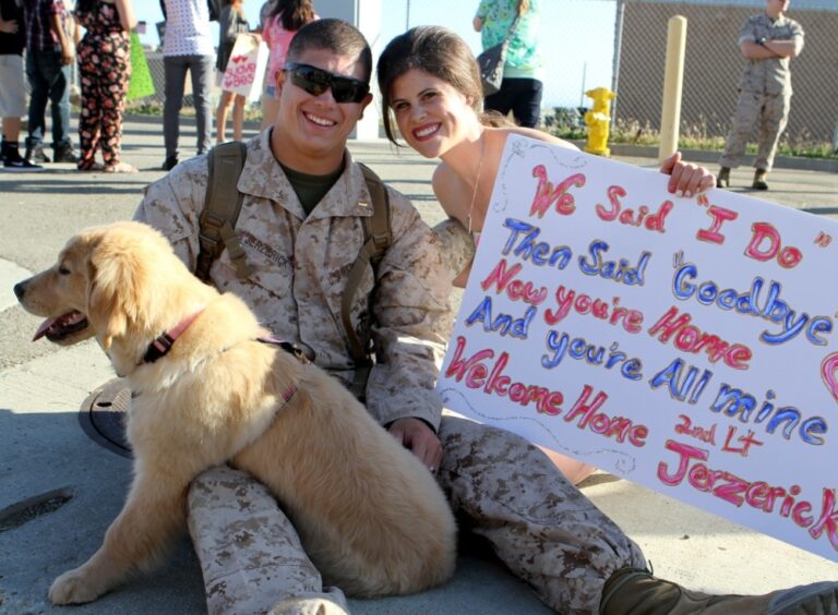 military couple with welcome home sign