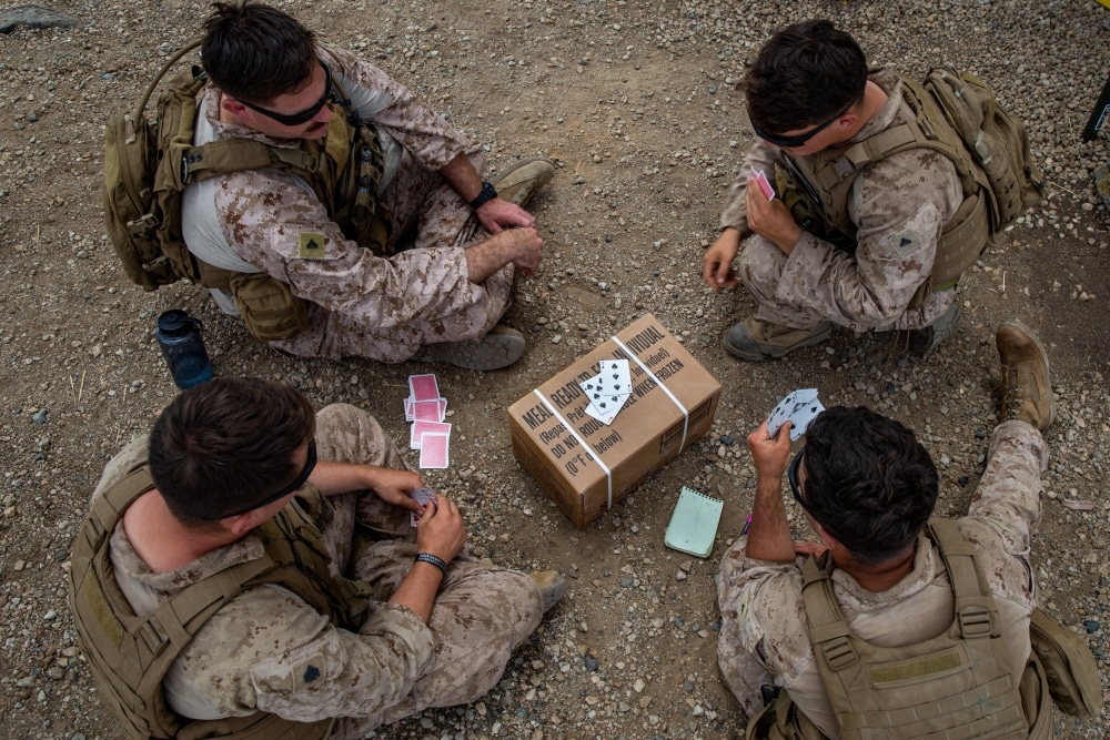 marines playing cards on ground