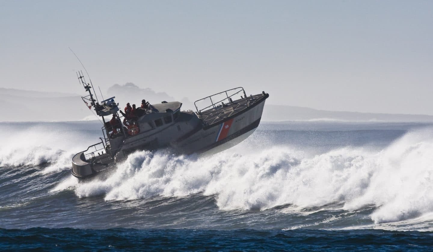 coast guard boat jumps the surf