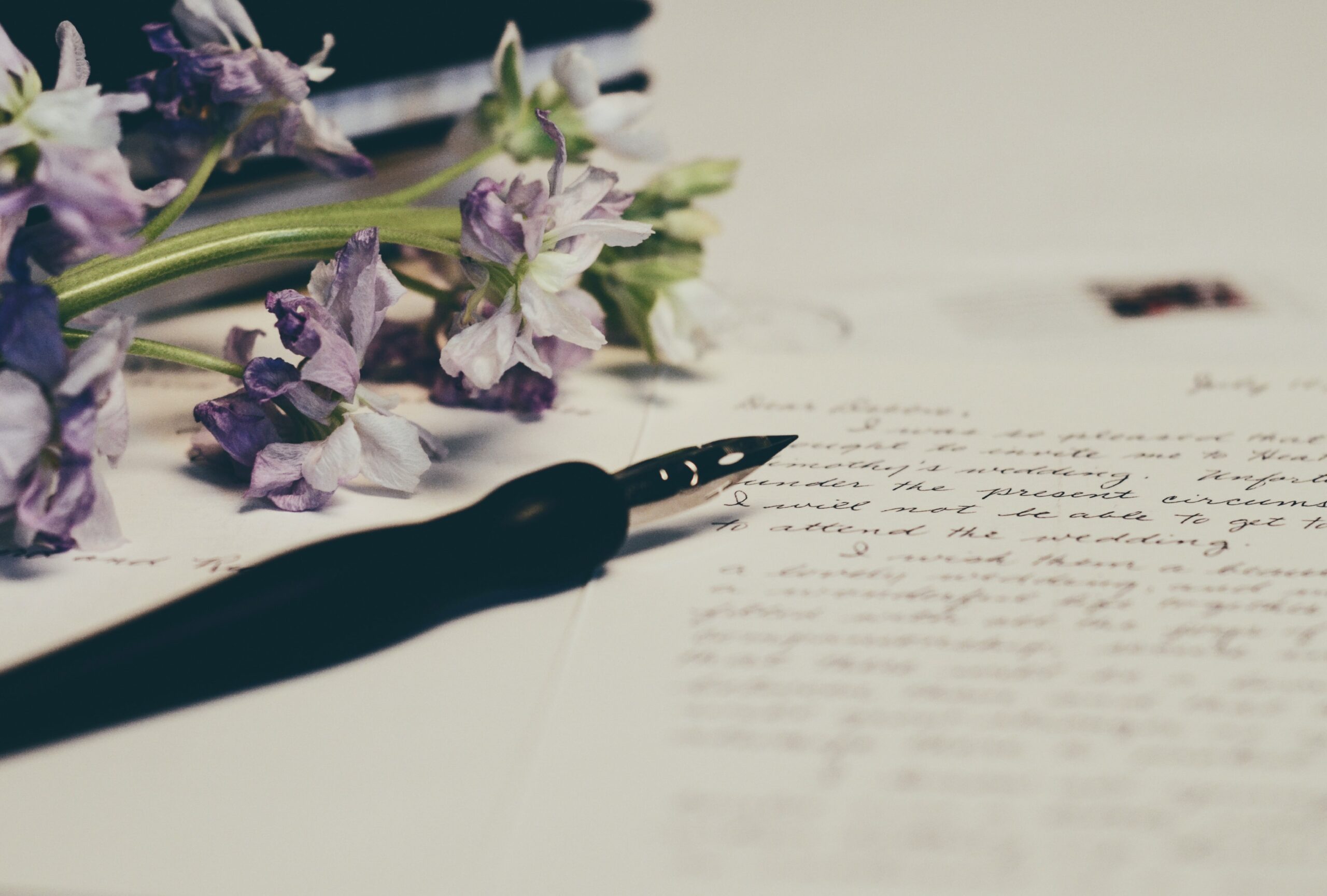 letter with pen and flowers
