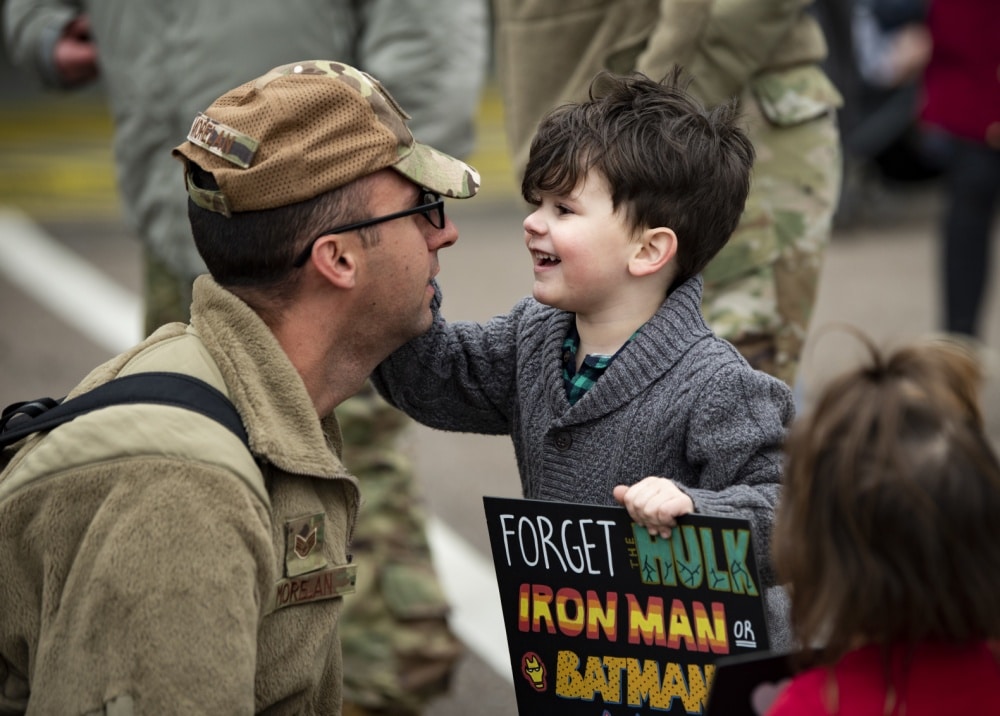 toddler greets dad during military family reunion