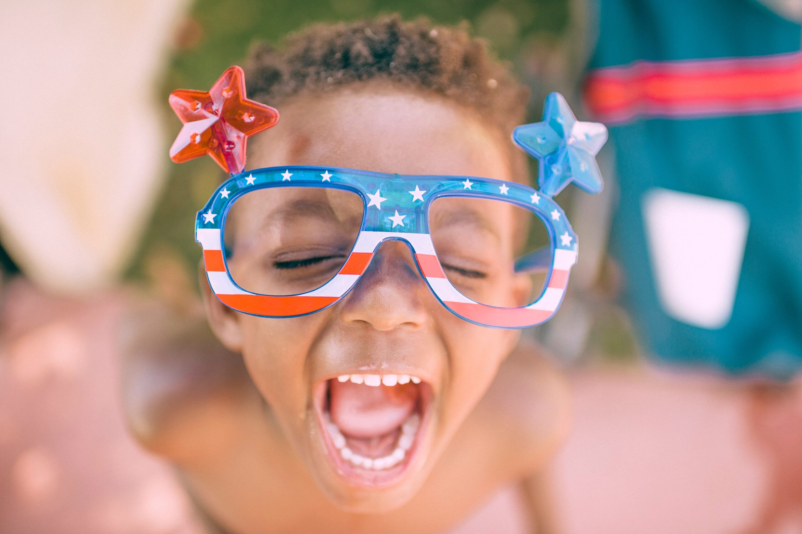 boy wearing american flag glasses