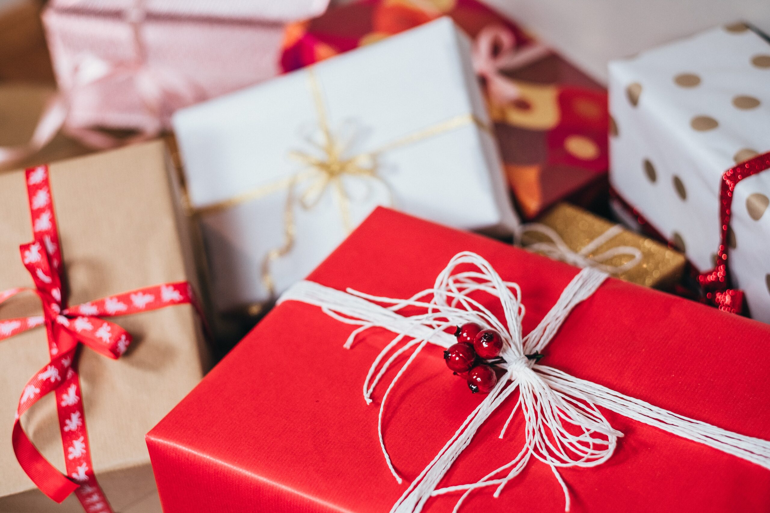 presents wrapped with ribbons in a pile