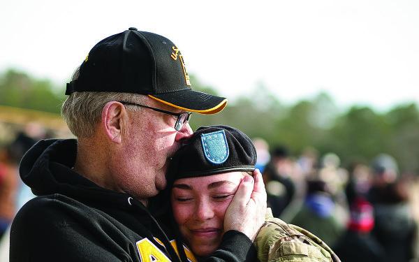 father hugs army daughter at fort jackson