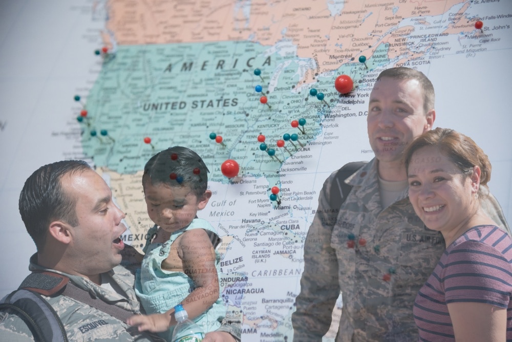 military family in front of pinned map 