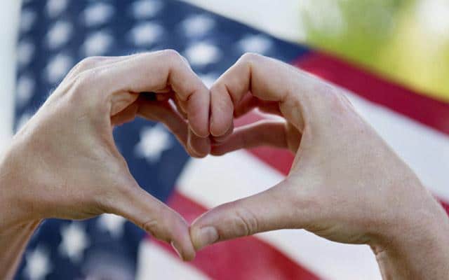 hands making a heart with american flag