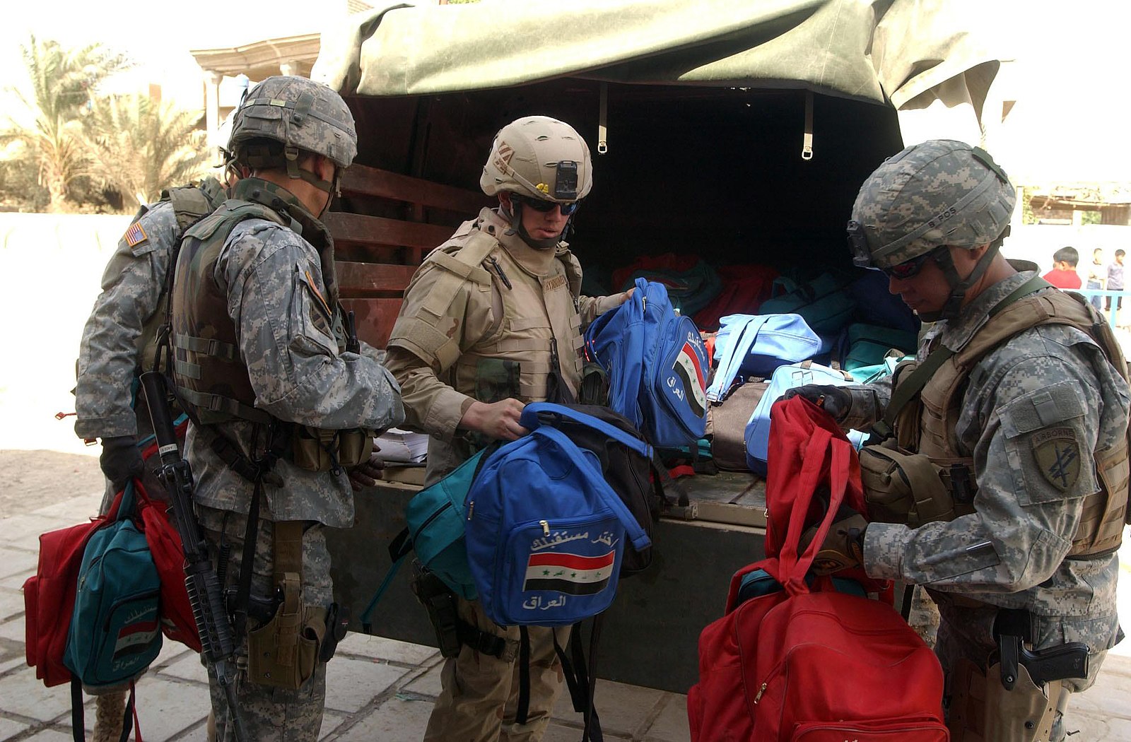 soldiers give away school supplies in Safia