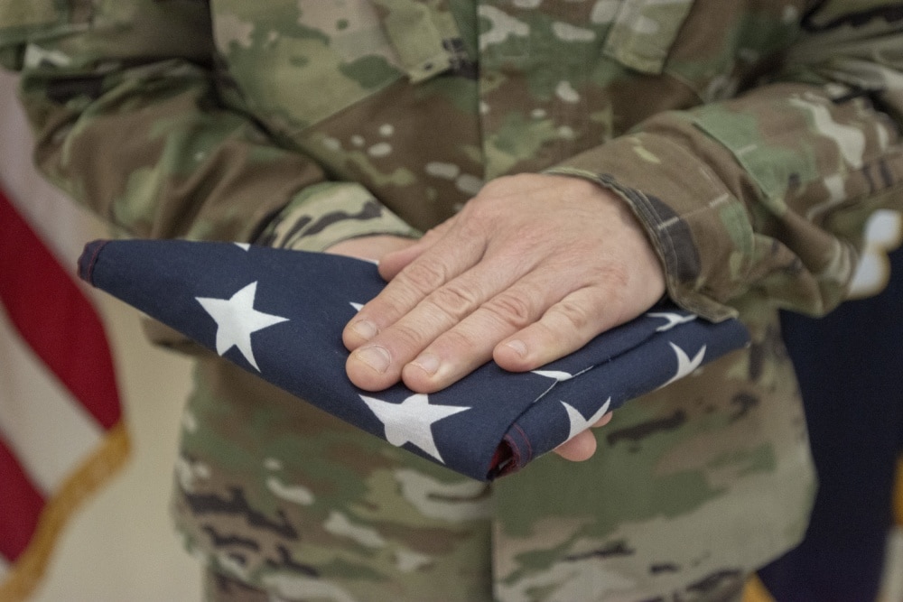 reserve soldier with flag in hands 