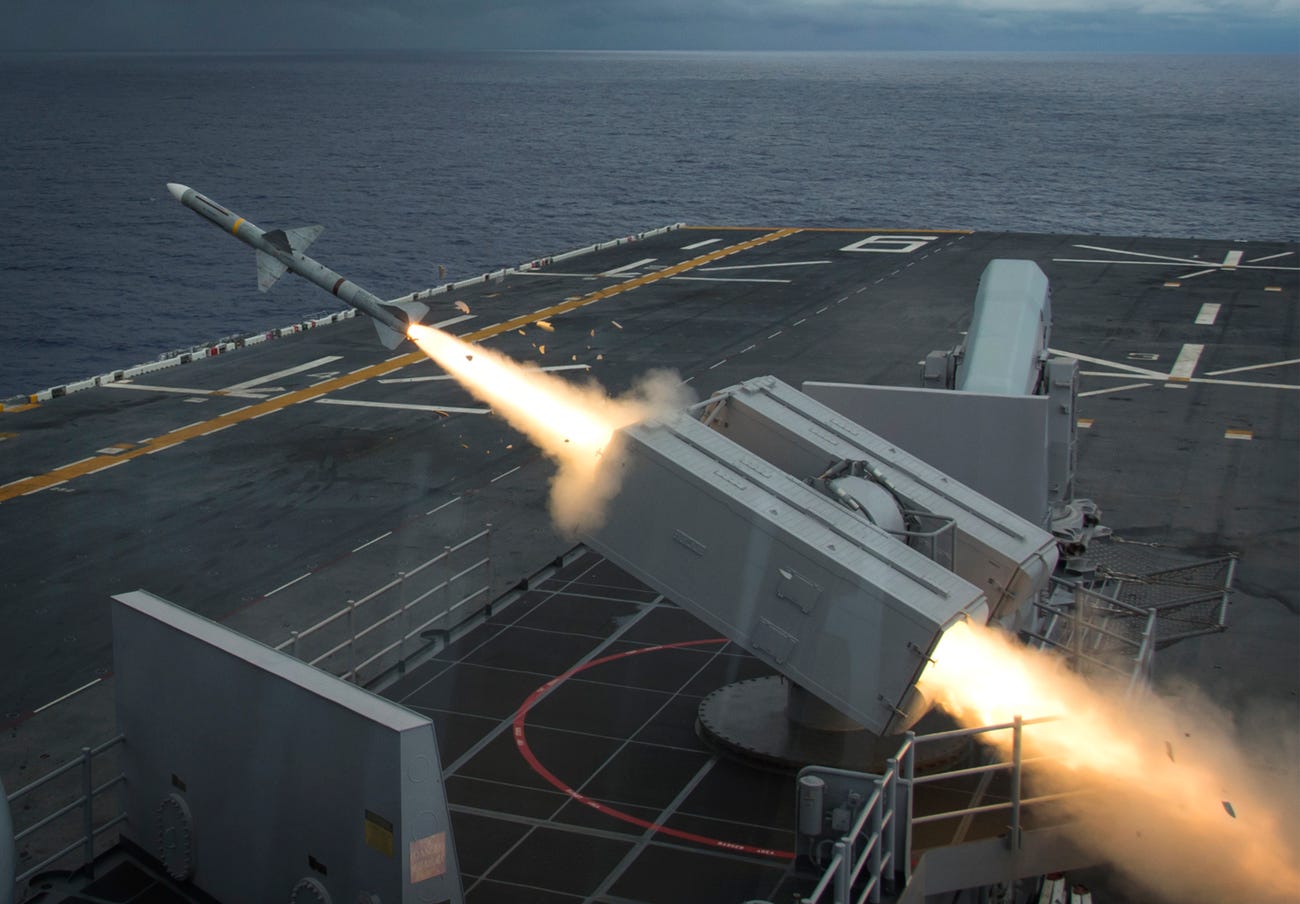 A missile firing from a ship, producing flames.