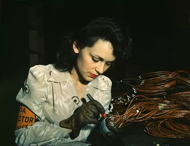 woman working on aircraft parts in WW2
