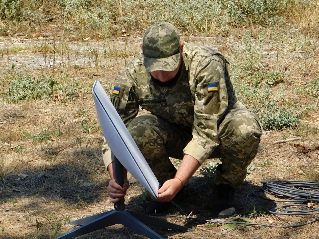 Ukrainian soldier setting up Starlink