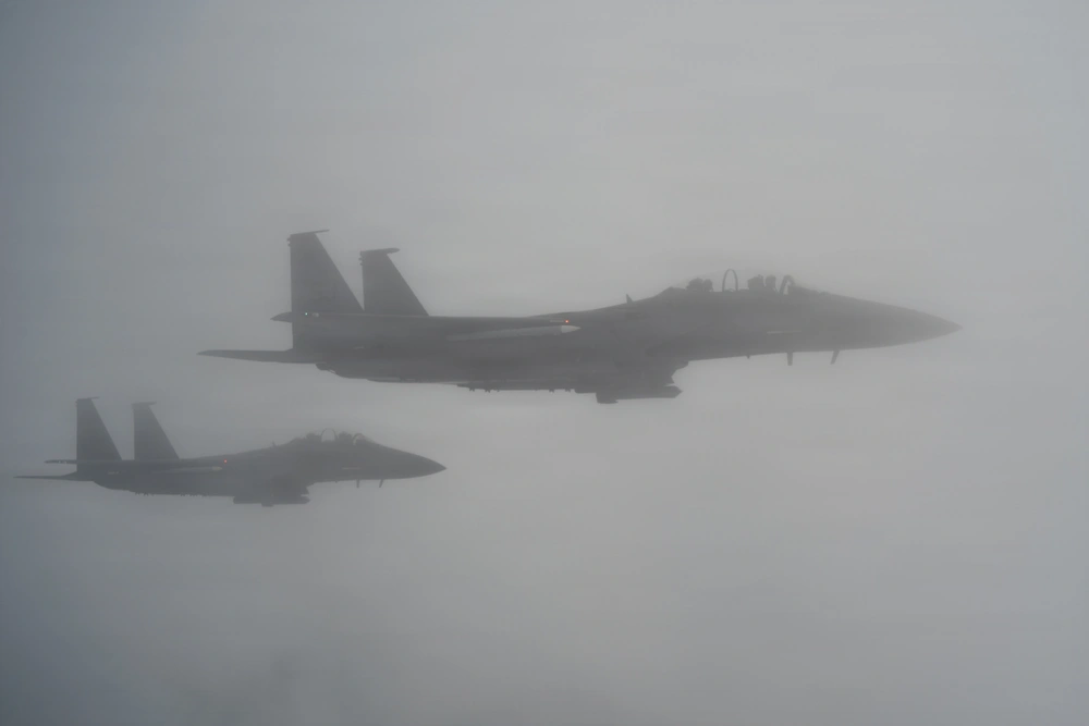 F-15E Strike Eagles fly through clouds