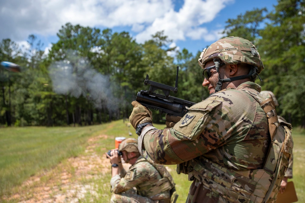 Soldier fires an M320 grenade launcher