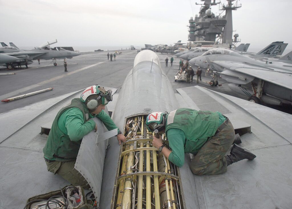 aircraft technicians work on F-14 on aircraft carrier
