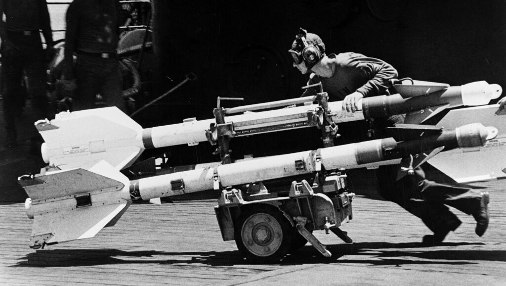 missile loading on aircraft carrier jet