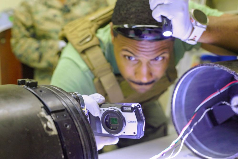 Marines conduct sensitive site exploitation on underwater drone