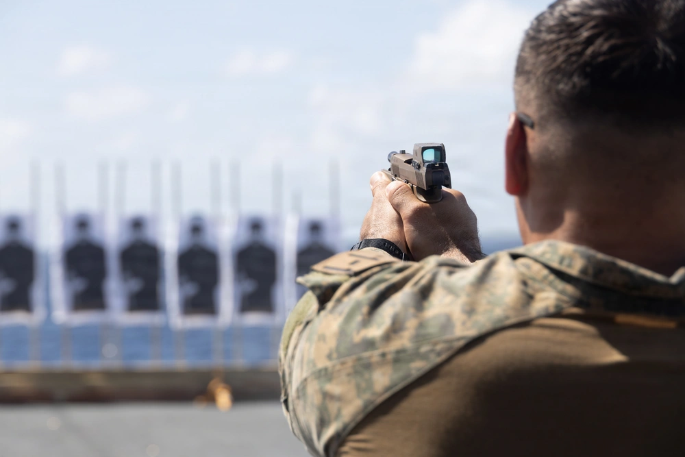 Marine fires M18 pistol during annual pistol qualification