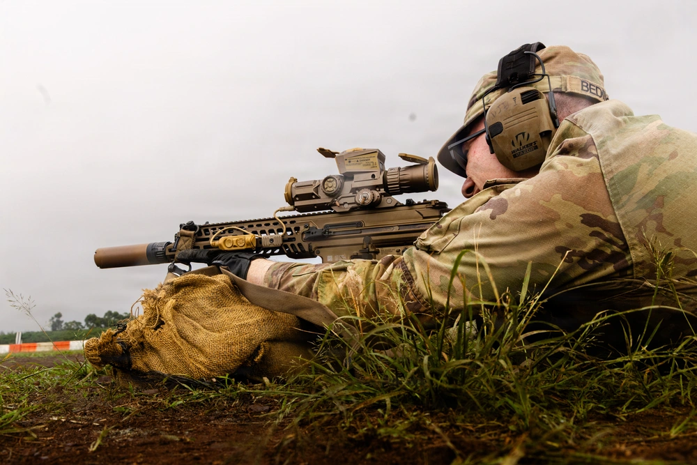 soldier fires M7 rifle
