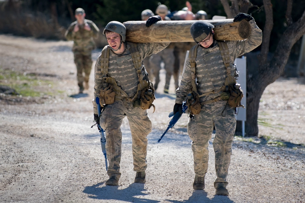 Air Force cadets carry log