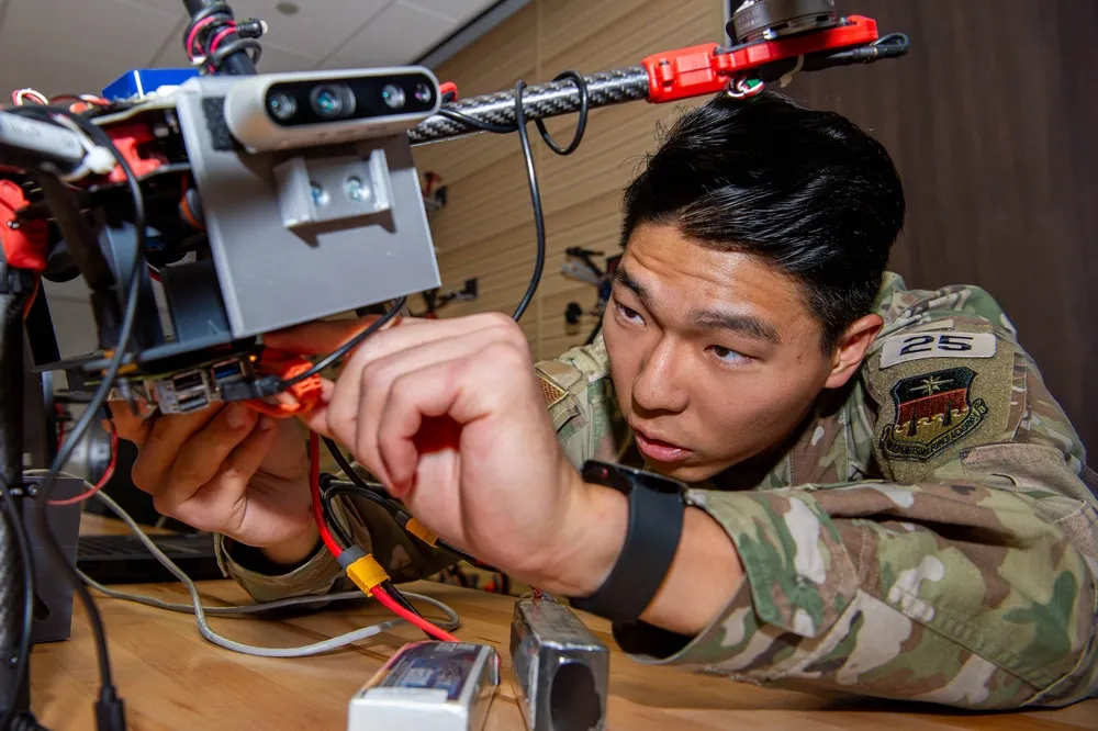 air force cadet works on drone