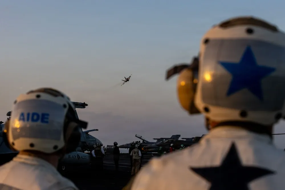 F/A-18 flies over USS Abraham Lincoln during operation epic fury